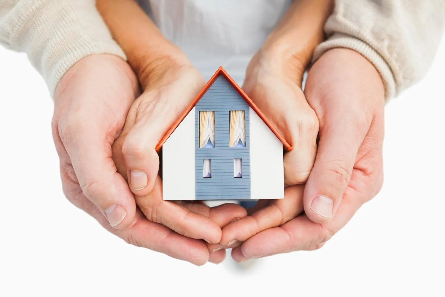A couple holding a small model house
